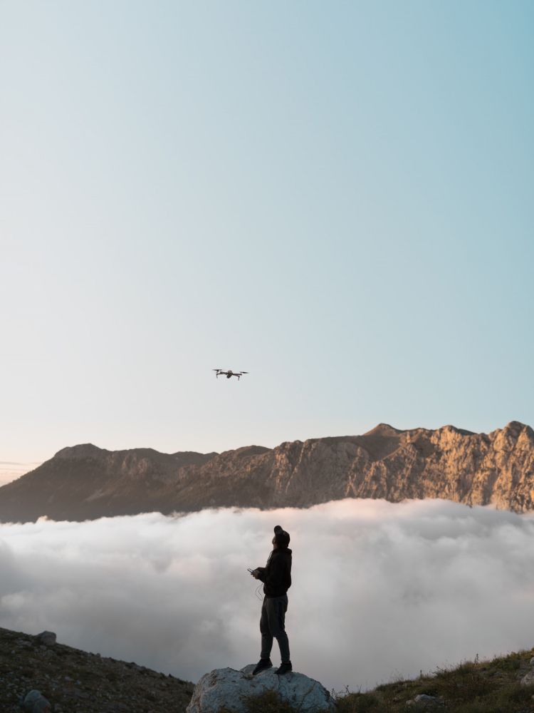 Man With Drone Mountains Flying Clouds