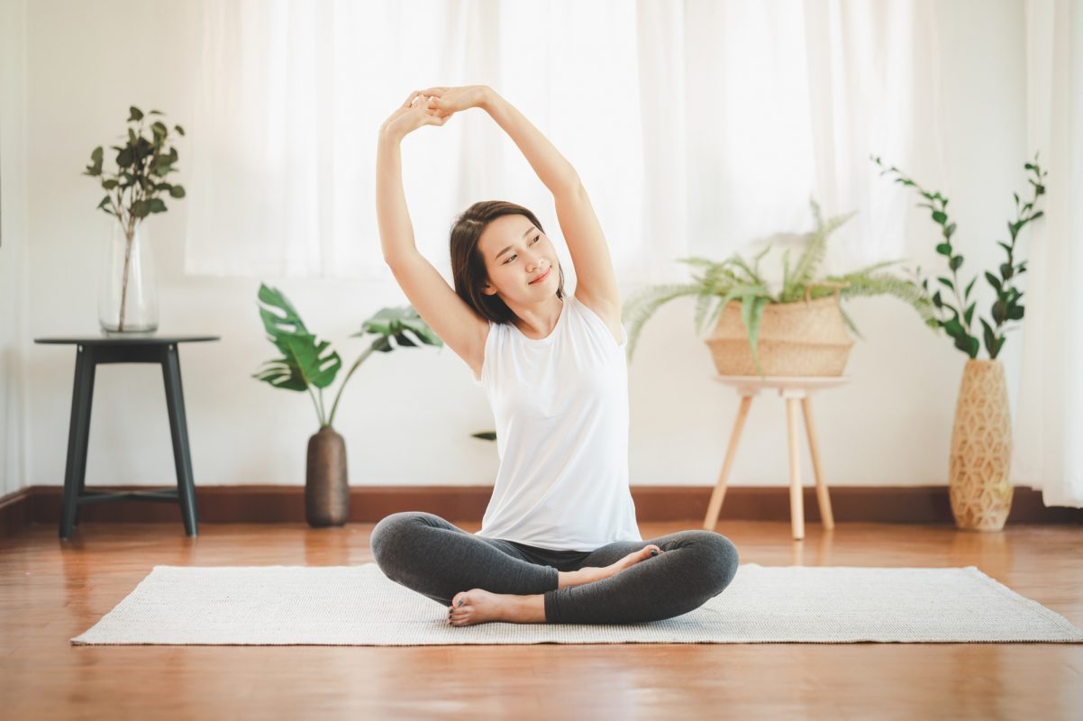 Smiling Healthy Asian Woman Doing Yoga Shoulder Stretching Home